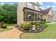 Charming front yard with landscaped garden and covered porch at 155 Edgewater Trl, Canton, GA 30115