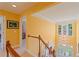 Bright and airy hallway showcasing chandelier, staircase, and open design, creating a welcoming space at 155 Edgewater Trl, Canton, GA 30115
