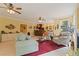 Inviting living room with multiple seating areas, bright windows, and ceiling fans for a comfortable atmosphere at 155 Edgewater Trl, Canton, GA 30115