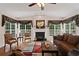 Bright living room with fireplace, hardwood floors, and large windows at 155 Edgewater Trl, Canton, GA 30115