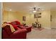 Bright and comfortable living room featuring a plush red sectional, light wood floors, and inviting decor at 155 Edgewater Trl, Canton, GA 30115
