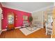 Comfortable living room features hardwood floors, bright accent wall, and seating at 155 Edgewater Trl, Canton, GA 30115