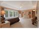 Expansive main bedroom with a tray ceiling, large windows, and dual dressers at 155 Edgewater Trl, Canton, GA 30115