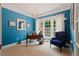 Bright office space with blue walls, chandelier lighting, and large windows at 155 Edgewater Trl, Canton, GA 30115