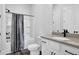 Bathroom featuring a shower-tub combo with decorative curtain and a stylish vanity with black fixtures at 2139 Kirkham Way, Kennesaw, GA 30152