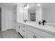 Bathroom with double vanity sinks, black hardware, tiled floors, and an elegant walk-in shower at 2139 Kirkham Way, Kennesaw, GA 30152