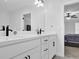 Bathroom featuring a dual sink vanity with black hardware and a large mirror above at 2139 Kirkham Way, Kennesaw, GA 30152