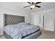 This bedroom has a decorative ceiling fan, plush carpet, and a view into the Primary bath at 2139 Kirkham Way, Kennesaw, GA 30152