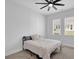 Simple bedroom features a modern ceiling fan, two windows and a comfortable bed with neutral bedding at 2139 Kirkham Way, Kennesaw, GA 30152