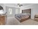 Bright bedroom featuring a ceiling fan, carpeted floors, and ample natural light from dual windows at 2139 Kirkham Way, Kennesaw, GA 30152