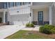 Close-up of a townhome featuring a two-car garage, stone accents, and a welcoming front entrance at 2139 Kirkham Way, Kennesaw, GA 30152