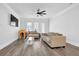 Bright living room featuring modern furniture, a ceiling fan, and plenty of natural light at 2139 Kirkham Way, Kennesaw, GA 30152