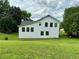 Rear exterior view of a two-story home with an expansive backyard lawn at 23 Jennifer Ln, Rydal, GA 30171