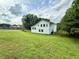 Spacious backyard featuring a well-maintained lawn and the rear of a two-story home at 23 Jennifer Ln, Rydal, GA 30171