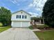 Charming two-story home featuring a front porch, two-car garage, and neat landscaping at 23 Jennifer Ln, Rydal, GA 30171