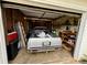 Messy garage with vehicle, ladders, and storage shelves at 23 Jennifer Ln, Rydal, GA 30171