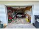 Cluttered garage with car, lawn equipment, and storage at 23 Jennifer Ln, Rydal, GA 30171