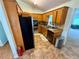 Functional kitchen featuring stainless steel appliances, wooden cabinetry, and neutral toned tile floors at 23 Jennifer Ln, Rydal, GA 30171