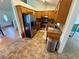 Functional kitchen featuring stainless steel appliances, wooden cabinetry, and neutral toned tile floors at 23 Jennifer Ln, Rydal, GA 30171