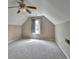 Attic featuring carpet, window with curtains, ceiling fan, and neutral colored walls at 3865 Portico Run Dr, Buford, GA 30519
