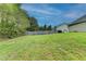 Spacious backyard with lush green grass and a wooden fence creating a private space at 3865 Portico Run Dr, Buford, GA 30519