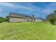 Expansive backyard with lush green grass and siding of the house, creating an inviting outdoor space at 3865 Portico Run Dr, Buford, GA 30519