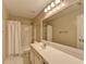 Bathroom featuring a shower with curtain, toilet, and sink with vanity at 3865 Portico Run Dr, Buford, GA 30519