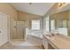 Bright bathroom featuring a shower, tub, window, and sink with vanity at 3865 Portico Run Dr, Buford, GA 30519