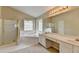 Bright bathroom featuring a shower, tub, window, and double sink vanity with ample lighting at 3865 Portico Run Dr, Buford, GA 30519