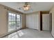 Bedroom featuring a window, ceiling fan, carpet, closet and door at 3865 Portico Run Dr, Buford, GA 30519