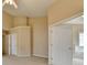 Bright bedroom with neutral walls and carpet, showcasing adjoining doors to other rooms at 3865 Portico Run Dr, Buford, GA 30519