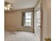 Bright bedroom with neutral walls, carpet, ceiling fan, and window offering natural light at 3865 Portico Run Dr, Buford, GA 30519