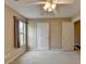 Bright bedroom with neutral walls, carpet, ceiling fan, and window offering natural light at 3865 Portico Run Dr, Buford, GA 30519