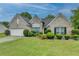 Charming one-story brick home featuring a well-manicured lawn and attached two-car garage at 3865 Portico Run Dr, Buford, GA 30519