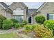 Charming brick home with a well-manicured front yard and lush landscaping at 3865 Portico Run Dr, Buford, GA 30519