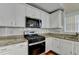 Bright kitchen with stainless appliances, granite countertops and white cabinets at 3865 Portico Run Dr, Buford, GA 30519