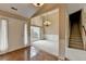 Open living room with staircase, light-colored carpet, and large windows for natural light at 3865 Portico Run Dr, Buford, GA 30519