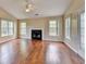 Bright living room featuring a fireplace, hardwood floors, and a ceiling fan at 3865 Portico Run Dr, Buford, GA 30519