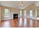 Spacious living room with fireplace, windows, vaulted ceiling, and hardwood floors at 3865 Portico Run Dr, Buford, GA 30519