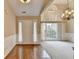 Bright living room featuring hardwood floors, a vaulted ceiling, and a chandelier at 3865 Portico Run Dr, Buford, GA 30519
