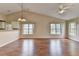 Open-concept living room with vaulted ceiling, hardwood floors, and large windows at 3865 Portico Run Dr, Buford, GA 30519