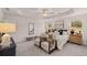 Well-appointed main bedroom featuring trey ceiling, carpet, sitting area, and large window at 50 Leggett Dr # 184, Villa Rica, GA 30180