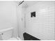 Shower featuring subway tile, black hex tile flooring, and shower niche at 52 Chaumont Nw Sq, Atlanta, GA 30327