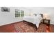 Cozy bedroom featuring a queen bed, hardwood floors, and a sunny window at 52 Chaumont Nw Sq, Atlanta, GA 30327