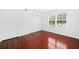 Bright bedroom with hardwood floors and a closet near a window at 52 Chaumont Nw Sq, Atlanta, GA 30327