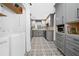 Charming kitchen featuring gray cabinets, patterned tile floors, and modern appliances at 52 Chaumont Nw Sq, Atlanta, GA 30327