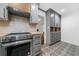 Kitchen boasts gray cabinetry, stainless steel oven, and decorative tile flooring at 52 Chaumont Nw Sq, Atlanta, GA 30327