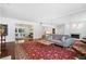 Spacious living room with hardwood floors, mirror, and a vibrant red patterned rug at 52 Chaumont Nw Sq, Atlanta, GA 30327