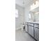 Bright bathroom featuring a white vanity, large mirror, modern lighting, and tile flooring at 621 Pineberry Ct, Grayson, GA 30017