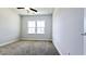 This light-filled bedroom offers plush carpeting and a modern ceiling fan at 621 Pineberry Ct, Grayson, GA 30017